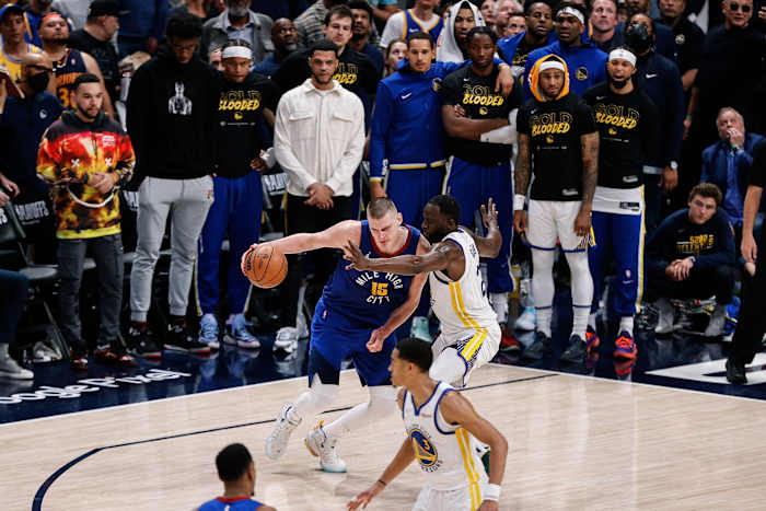 Apr 21, 2022; Denver, Colorado, USA; Denver Nuggets center Nikola Jokic (15) controls the ball as Golden State Warriors forward Draymond Green (23) defends in the fourth quarter during game three of the first round for the 2022 NBA playoffs at Ball Arena. Mandatory Credit: Isaiah J. Downing-USA TODAY Sports
